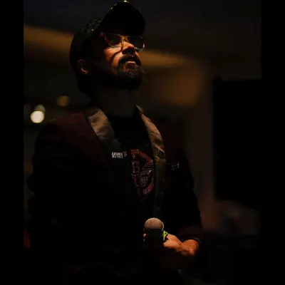 A moody shot with my microphone. The mic has become a part of me, a tool to connect, entertain, and create magic.