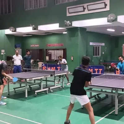 A typical training evening at our academy, with multiple matches in progress. The facility is designed to accommodate numerous players, ensuring everyone gets ample table time.