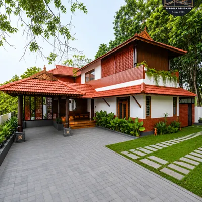 This carport is designed as an integral part of a traditional Kerala-style home. The sloped roof with classic clay tiles and wooden accents matches the main house perfectly, creating a harmonious and authentic architectural look for the entire property.
