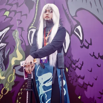 A cosplayer poses in front of a vibrant, custom backdrop at Comic Con India. I make sure to use the event's unique environment to create memorable photos.