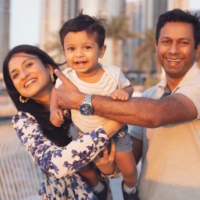 A candid family moment during a golden hour shoot in Dubai. The warm light and genuine smiles create a perfect, happy memory.