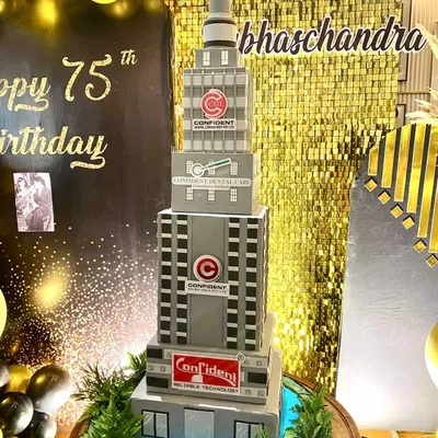 We were commissioned to create this massive building cake for a 75th birthday celebration. Standing over 4 feet tall, it's a replica of the company's buildings, complete with a lake and greenery at the base.
