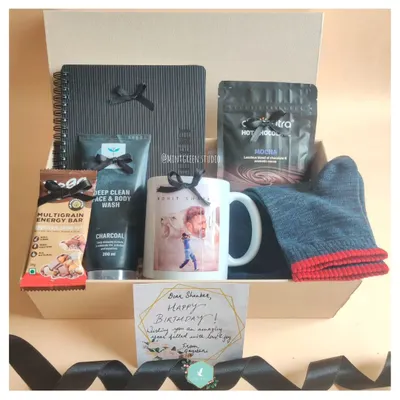 A birthday hamper designed for a cricket fan. It includes a personalized mug with his favorite player, charcoal face wash, hot cocoa, and other treats to make his day special.