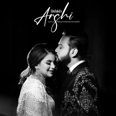 A tender black and white portrait of the groom kissing the bride's forehead, a classic and intimate moment filled with love.