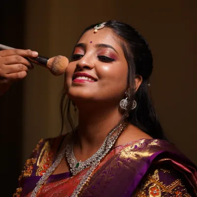 The getting-ready process should be just as joyful as the main event. Here I am adding the finishing touches, ensuring my bride feels relaxed, happy, and confident. It’s all about creating that perfect, stress-free vibe.