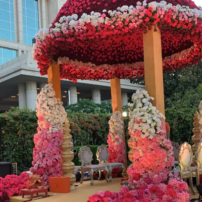 A true pink paradise for a union of hearts. This magnificent dome mandap is covered in thousands of ombre pink and white roses, creating an enchanting and regal space for the wedding ceremony at the Taj Santacruz.