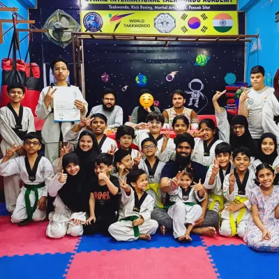 A happy group photo of my students after a successful belt promotion test at the academy. Everyone is proud of their new ranks.