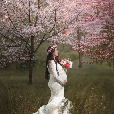 A truly magical moment for this mom-to-be, standing in a beautiful grove of pink cherry blossoms. This ethereal pregnancy portrait captures the wonder and beauty of awaiting a new life.