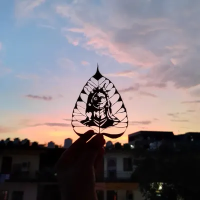 This carving of Adi Yogi is a piece I am very proud of. The natural veins of the Peepal leaf complement the design, and holding it against the sky creates a powerful, meditative image.