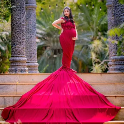 The full, dramatic effect of a red trail gown for a maternity shoot. I specialize in styling these flying gowns to create powerful and majestic portraits for mothers-to-be.