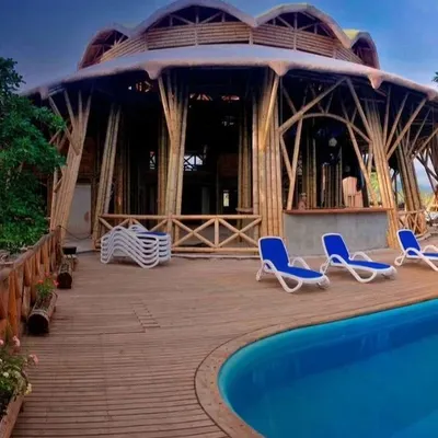 This stunning poolside resort structure showcases the architectural possibilities of bamboo. The soaring, tree-like supports and curved roof create a breathtaking, open-air space that is both grand and in harmony with nature.