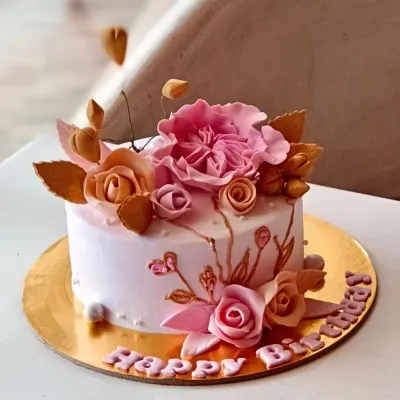 This elegant birthday cake with handcrafted sugar flowers is a great example of my custom design work. I can create personalized cakes for any theme or style.