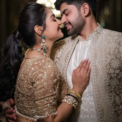 A coordinated couple look is more than just matching colors. It's about complementary textures and embroidery, like his subtly detailed coat next to my shimmering lehenga, creating a harmonious picture.