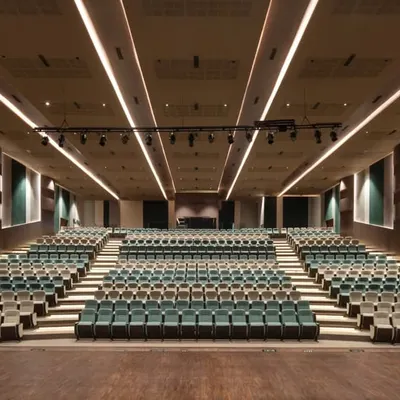 The heart of the school's cultural life, this 550-seat auditorium is designed for excellence. The sweeping view showcases the tiered seating, professional lighting rig, and acoustically treated walls that ensure every performance is seen and heard perfectly.