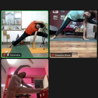A screenshot from my online yoga class, showing students in various poses. I use props like blocks and chairs even in online sessions to ensure proper alignment.