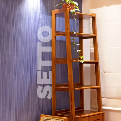 The Setto bookshelf, seen here against a textured wall, is a classic and chic storage solution. Its open shelves are perfect for books and decor, while the lower cabinet keeps things tidy.