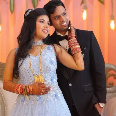 A classic reception look featuring a groom in a sharp tuxedo. The styling is elegant and timeless, with a focus on natural-looking skin and perfectly coiffed hair for a night of celebration.