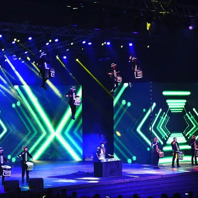My Aerial Drumming Troupe performing for a major corporate event with Infosys. This act involves multiple drummers suspended from the ceiling, creating a 360-degree performance that fills the entire venue with energy and sound.