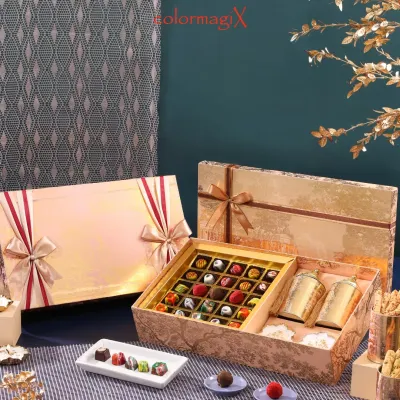 Indulge the senses with our exquisite chocolate and sweets boxes. This opulent gold-foiled hamper contains an assortment of handcrafted chocolates and premium treats, perfect for the discerning connoisseur.