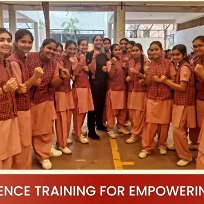 A group of empowered students from Gargi Girls School posing in a fighting stance after their self-defense session.
