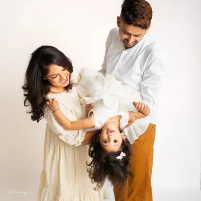 Pure, uninhibited fun during a family photoshoot. This playful moment, with the daughter held upside down, perfectly captures the joyful and candid spirit I love to photograph.