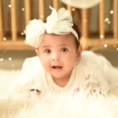 A simple and beautiful close-up of a sweet baby girl. Using a soft, fluffy rug and gentle lighting, I keep the focus entirely on her innocent expression.