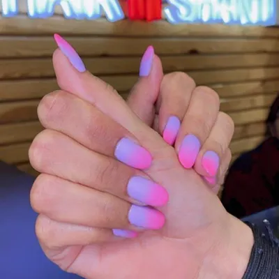 Our popular pink and purple ombre nails with a sophisticated matte finish. This style is perfect for those who love a smooth color transition and a bold, vibrant look on almond-shaped extensions.