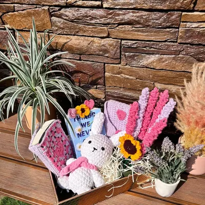 The perfect gift box for your book-loving friend. We curated this special hamper with a book, a handmade crochet bunny plushie, a crochet book sleeve, and flower bookmarks.