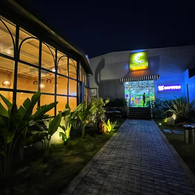 This is where the adventure begins. The entrance to Climb City at night, leading from our cafe and outdoor area into the main climbing gym. I've designed the space to be welcoming from the moment you arrive.