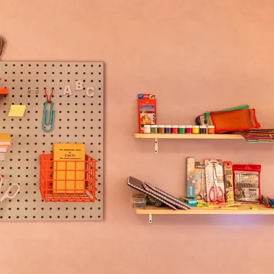 A close-up of the 'Stationery Shop' setup for a 25th anniversary. We sourced nostalgic items to make the experience authentic and fun, reminding guests of their school days.