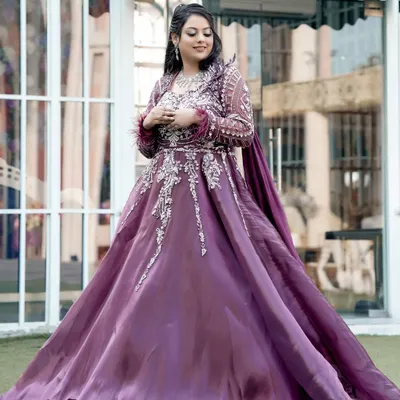 A full-length portrait of the bride in her magnificent purple engagement gown, a picture of pure elegance.