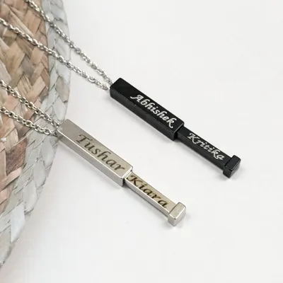 Keep your loved one's name close with this hidden name bar pendant. One name is visible, while the other slides out for a sweet surprise. It’s available in both black and silver stainless steel.