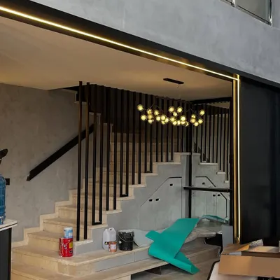 Proof that 'under construction' can still have style. With the dramatic staircase, modern railings, and integrated lighting already in place, this space looks cool even before it's finished.