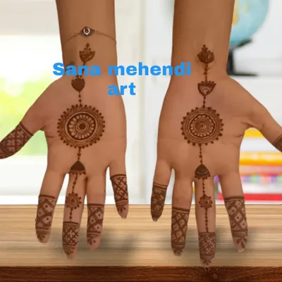 A perfect example of a jewellery-style mehndi design. This pattern mimics a haath phool (hand harness), with a central mandala and chains connecting to the fingers.