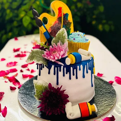 An example of a highly custom, art-themed cake I designed for a creative soul. This eggless cake features edible fondant paint tubes, brushes, and a painter's palette, complete with a surprise cupcake on top. If you have a unique theme in mind, I can bring it to life.