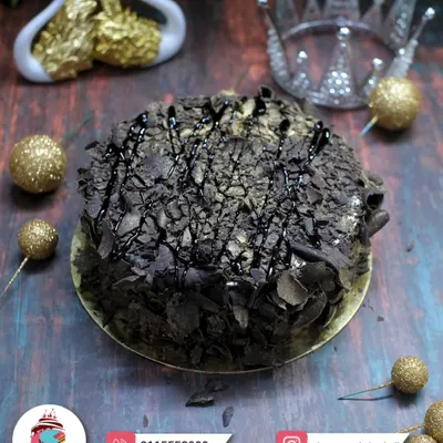A rich and decadent chocolate overload cake. Covered in chocolate shavings and drizzle, it's a dream come true for any chocolate lover.