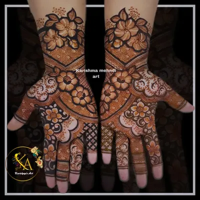 A stunning floral design where large, shaded flowers are the main focus. The symmetrical pattern flows from the forearms to the fingertips, creating a look that is both bold and feminine.