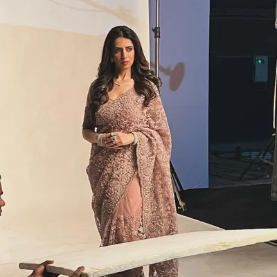 A behind the scenes shot from the "Vanshaj" poster shoot. Here, the actress is styled in an exquisite dusty pink lace saree, a look that defines her character's grace and sophistication.