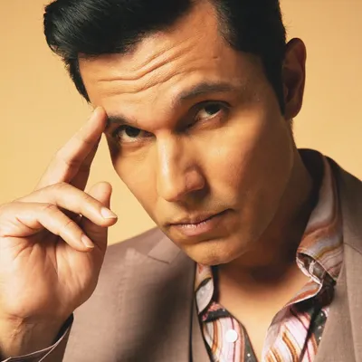 A close-up celebrity portrait of Randeep Hooda, capturing a moment of direct, intense connection with the camera. This is the kind of high-end headshot that commands attention.