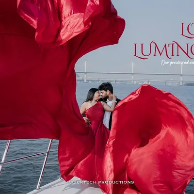 A creative shot from a Goa yacht pre-wedding session, where the bride's vibrant red dress fills the frame, creating a luminous and romantic portrait of the couple.
