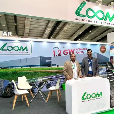 Our team at the Global Solar Expo, standing by our professionally designed booth. The backdrop highlights our upcoming 1.2 GW PV Module Factory, a testament to our commitment to scaling up solar manufacturing in India.