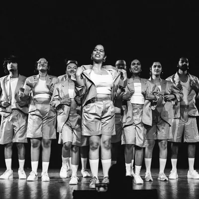 A powerful black and white shot capturing the unity and strength of our dancers in a group pose.