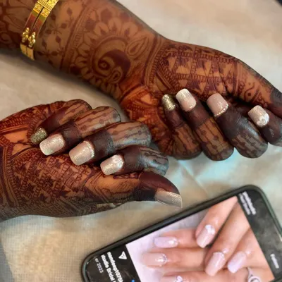 Beautiful custom nail art for my bride Poornima. She chose a delicate design with glitter and embellishments that perfectly matched her wedding attire. We offer this service through Narumugai Nail Art Studio.