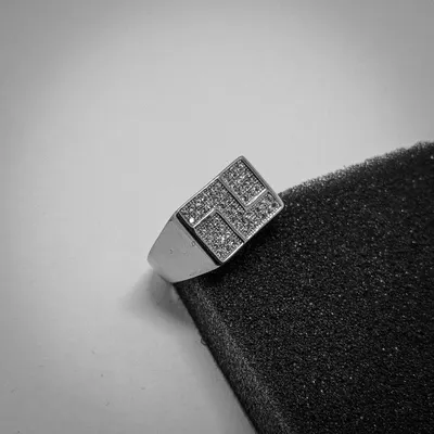 This high-contrast shot highlights the sharp, modern design of our geometric signet ring. The sterling silver band is topped with a pattern of sparkling CZ stones.