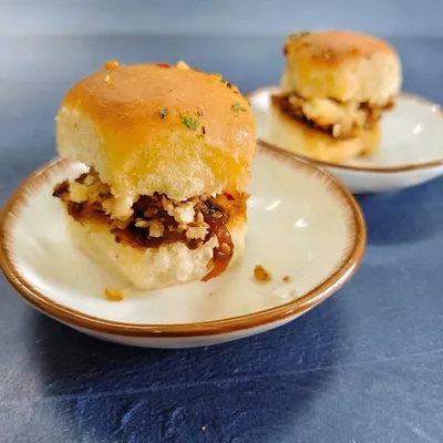 A gourmet twist on the beloved street-side classic. These mini fusion sliders are packed with a spicy, tangy masala, topped with crumbled paneer, and nestled in soft, butter-toasted buns.