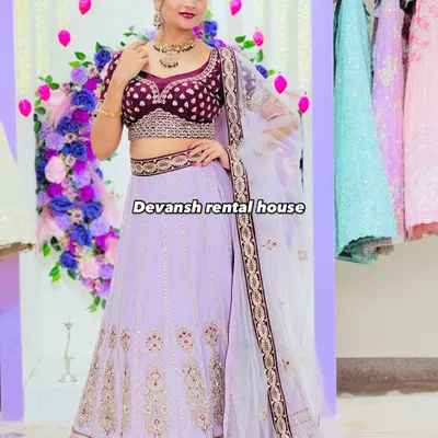 A stunning lavender lehenga with intricate embroidery, paired with a rich velvet blouse. This piece is available for rent and is perfect for a sangeet or reception, giving you a royal look.
