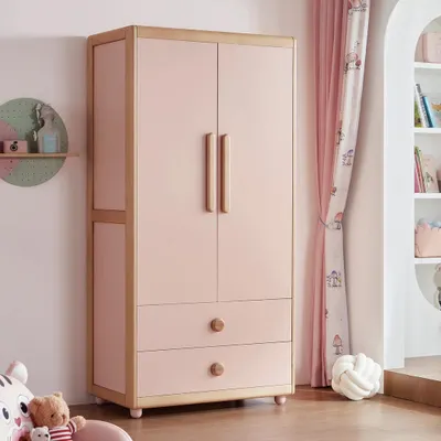 A charming wardrobe for a child's room, featuring a soft pink finish with natural wood accents. The design includes easy-to-reach drawers and handles suitable for kids.