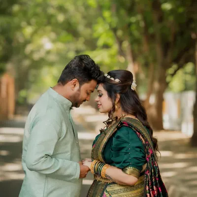 A beautiful, intimate portrait from a cross-cultural engagement shoot. The couple, dressed in elegant traditional wear, shares a quiet moment that speaks volumes of their love.