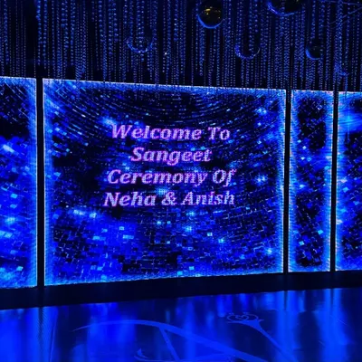 A futuristic and dazzling welcome screen for Neha and Anish's Sangeet ceremony. We used a large LED wall with cosmic-themed graphics to build excitement for a night of music and dance.