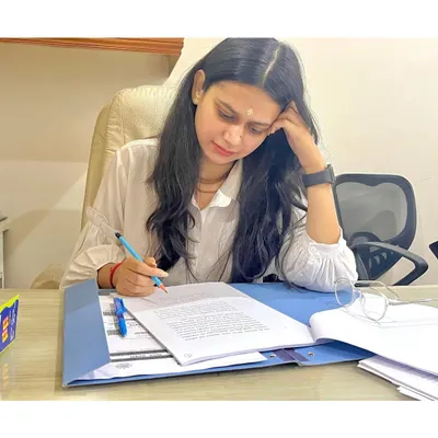 The real work of a lawyer often happens away from the courtroom. Here, I am meticulously reviewing case files and drafting documents, ensuring every detail is perfect before we proceed. My focus is on building a strong, unshakeable case for you.